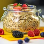 clear glass jar with black berries