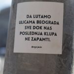 a sticker on a pole on a city street